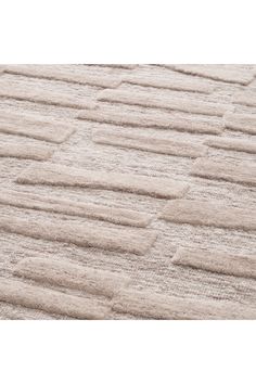 a white rug with squares and lines on it