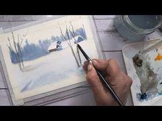 someone is painting trees in the snow with watercolors