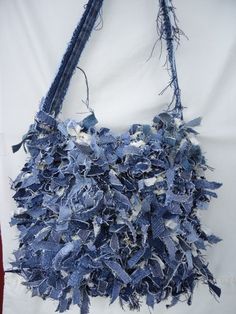 a bag made out of old jeans hanging on a wall