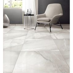 a chair and table in a room with white marble flooring on the walls,