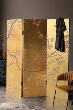 the room divider is decorated with gold and pink flowers on it's side