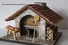 a miniature model of a stone oven with eggs in it