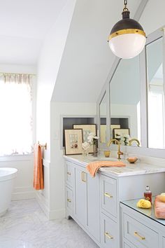 a bathroom with a tub, sink and large mirror on the wall next to it