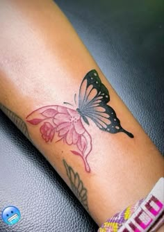 a woman's arm with a butterfly tattoo on it