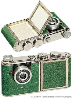 an old green camera with a mirror on it's front and side view showing the lens