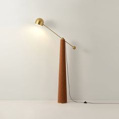 a floor lamp that is on top of a white table next to a light bulb