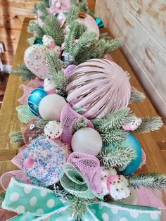 a long table with ornaments on it and ribbons tied around the top, along with polka dot bows