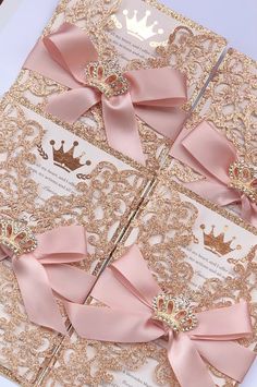 pink and gold wedding stationery with ribbon, tiara and crown brooches