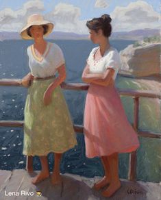 two women standing next to each other near the ocean