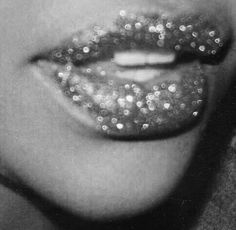 black and white photograph of a woman's lips with glitter on them