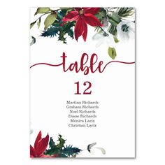 a table number card with poinsettis and holly