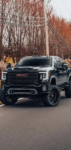 a black truck is parked on the street