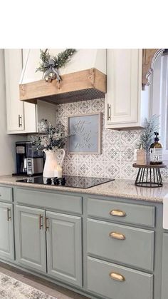 an instagram photo of a kitchen with white cabinets and gold handles