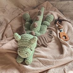 two crocheted stuffed animals laying on a bed