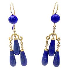 These elegant dangling earrings were made out of 14 karat gold in 1870 ca. The earrings are in designed in Greek revival taste. The earrings consists of tops set with a lapis lazuli bead with hooks that come with a safety device. From a short chains highlighted by a small diamonds hang curved elements from which three articulated drops shaped lapis lazuli elements per earring are suspended. The two lower drops are connected to the gold element a by pieces of gold chain decorated with small diamonds. The hooks are marked with Austrian gold hallmarks for 14 karat. The earrings were acid tested for 14 karat. Gold Element, Lapis Lazuli Beads, Greek Revival, Jewel Box, Dangling Earrings, Lapis Lazuli, Gold Chain, Gold Chains, Jewelry Earrings Dangle