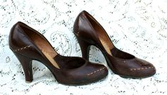 Original and not remakes, this is a pair of authentic 1940's brown leather pumps.   Of course, there is no size. I measured them from the inside and got approx. 9 1/4 inches. Please measure a pair od shoes that fit you well and compare to my measurements. The heels were measured from the back and are 3 inches. These are 3 inches wide. The insides say "Onco Insole  _____ated. You might want to add insoles.  Please see the photos. These are sturdy and very wearable.   Look at the little metal ring Fashion Boards, Pumps Shoes, Metal Ring, Leather Pumps, Style Board, Metal Rings, Pump Shoes, Of Course, Brown Leather