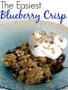 blueberry crisp in a bowl with whipped cream on top