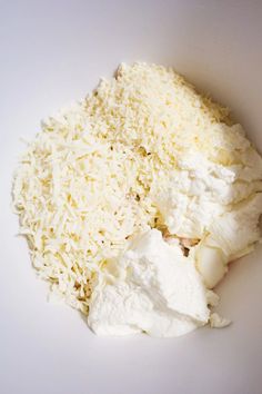 shredded cheese and other ingredients in a white bowl