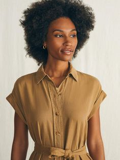 A classic shirt dress is one of our unsung wardrobe heroes. Inspired by utilitarian style, this one is made for the everyday with the same soft, just-stretchy-enough fabric of our fan favorite Arlie Day Pant. Specially dyed and washed for a vintage-inspired, lived-in vibe, we designed it with rolled cuffs, patch pockets, and cinched tie for that casually cool vibe that takes you from afternoon errands to dining alfresco. Fit: Relaxed fit. Length: 49 3/4" Detail: Horn button closure with removable self belt and on seam pockets. Material: 55% TENCEL™ Lyocell, 22% Linen, 21% Organic Cotton, 2% Elastane, Faux Horn Urea Buttons Model: Gabrielle is 5’9 wearing size Small Care: Machine wash cold. Remove promptly. Tumble dry low. Warm iron if needed. WDU2416-ABZ Tank Jumpsuit, Utilitarian Style, Classic Shirt Dress, Swim Pants, Stylish Clothes For Women, Linen Shop, Dress Shirts For Women, Sweater Sale, Shirtdress