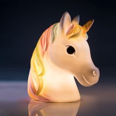 a glass figurine of a rainbow colored horse with black eyes and long mane