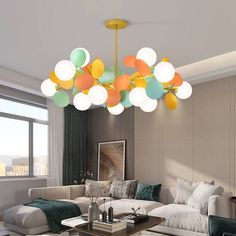 a living room filled with furniture and lots of balloons hanging from the chandelier