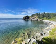 the water is crystal blue and clear with rocks on both sides in front of it