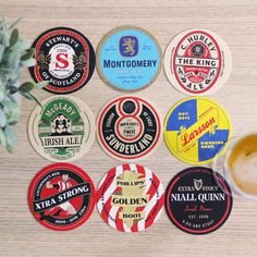 six different types of beer coasters sitting on a table next to a potted plant