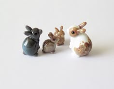 three small figurines of animals sitting next to each other