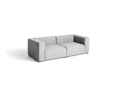 a gray couch sitting on top of a white floor