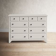 a white dresser sitting on top of a hard wood floor