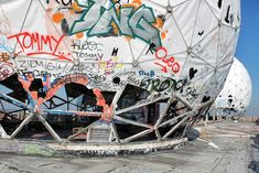 a large white structure with graffiti all over it