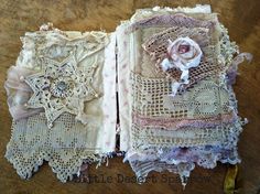 an open book with lace and flowers on it