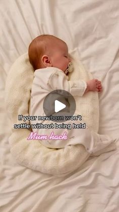 a baby laying on top of a white blanket next to a video message that reads, if your newborn won't settled without being held