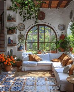 a living room filled with lots of furniture and plants on the wall next to a window