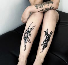 a woman sitting on top of a couch with tattoos on her legs