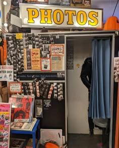 a man standing in the doorway of a photo shop