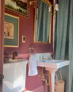 a white sink sitting under a mirror in a bathroom