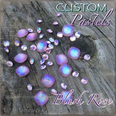 the words custom pastels are surrounded by purple and white jewels on a wooden surface