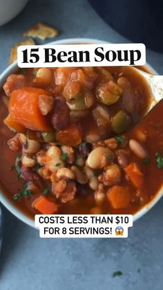 a white bowl filled with beans and carrots on top of a blue countertop