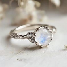 **Make a sparkling statement with this natural inspired Moonstone Engagement Ring at your next event. It's crafted in sterling silver, Gold/White Gold/Rose Gold bands. This ring is beautifully decorated with genuine Moonstones.  Gem:  Moonstone 8mm *This is a listing for one Moonstone Engagement Ring. We will carefully select a stone and make the piece for you.  Keep in mind, every piece we create is one-of-kind, with raw stones that differ in size, shape, and color. When ordering, anticipate so 2022 Rings, Moonstone Wedding Ring, Twig Ring, Jewelry Aesthetic, Moonstone Engagement, Semi Precious Gems, Moonstone Engagement Ring, Rings Rings, Floral Ring