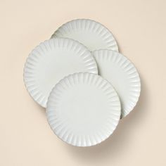 three white paper plates sitting on top of each other