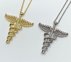 Caduceus Symbol Necklace, Medical Alert Charm, Medic Necklace Approx. Charm Size: 28mm x 24mm  Approx. Chain Length: 16 inches + 2 inches extension  Color: 2 options available: 1. Gold 2. Silver Material: 925 Sterling Silver, 18k gold plated, Cubic Zirconia Quantity: 1pc  Shipping Details: ♥ FREE SHIPPING to Canada via Canada Post for all orders above CA$100. Any orders above CA$50 will have a tracking number as well ♥ FREE SHIPPING to USA for all orders above US$35 via USPS First Class Mail Tra Rod Of Asclepius, Caduceus Symbol, Symbol Necklace, Medical Alert, Wedding Jewellery Necklace, Canada Post, Silver Material, Color 2, Wedding Necklace