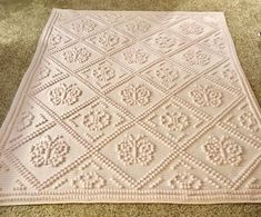 a white crocheted rug on the floor