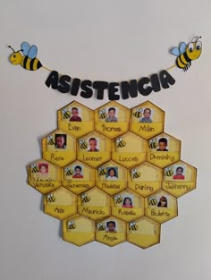 a bunch of bees are hanging on the wall with name tags in front of them