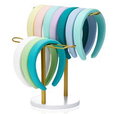 there are many different colored hair ties on the stand