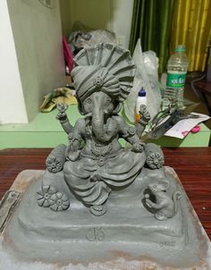 an elephant statue sitting on top of a wooden table