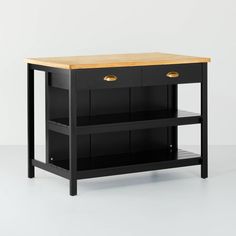 a black kitchen island with two drawers on one side and an open shelf at the top