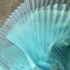 a close up view of the inside of a glass vase with blue swirls on it