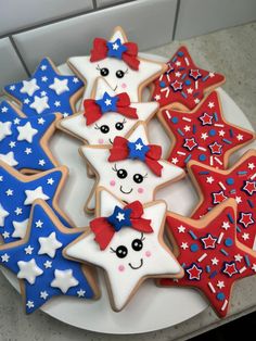 decorated cookies with red, white and blue decorations on a plate in the shape of stars