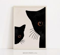 a black and white painting with two cats on it's face next to each other